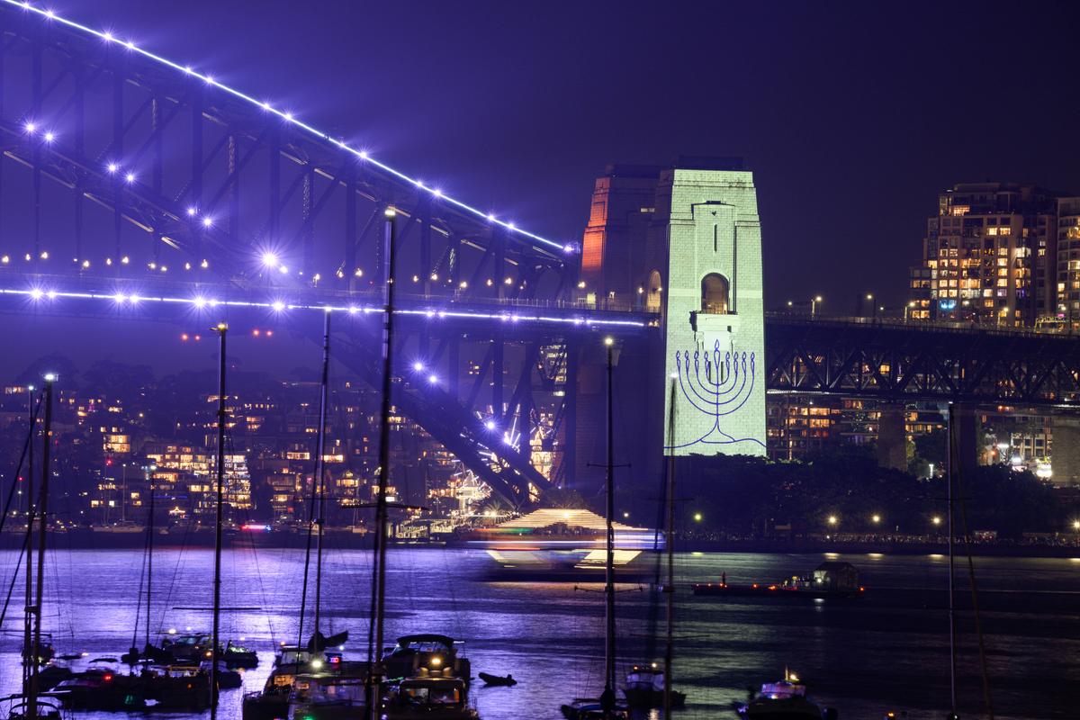 An image of a menorah is projected onto the pylons of the Sydney Harbour Bridge during New Year’s Eve celebrations in commemoration of the Bondi terror attack on Dec. 31, 2025. Dec. 14, 2025. (Izhar Khan/Getty Images)