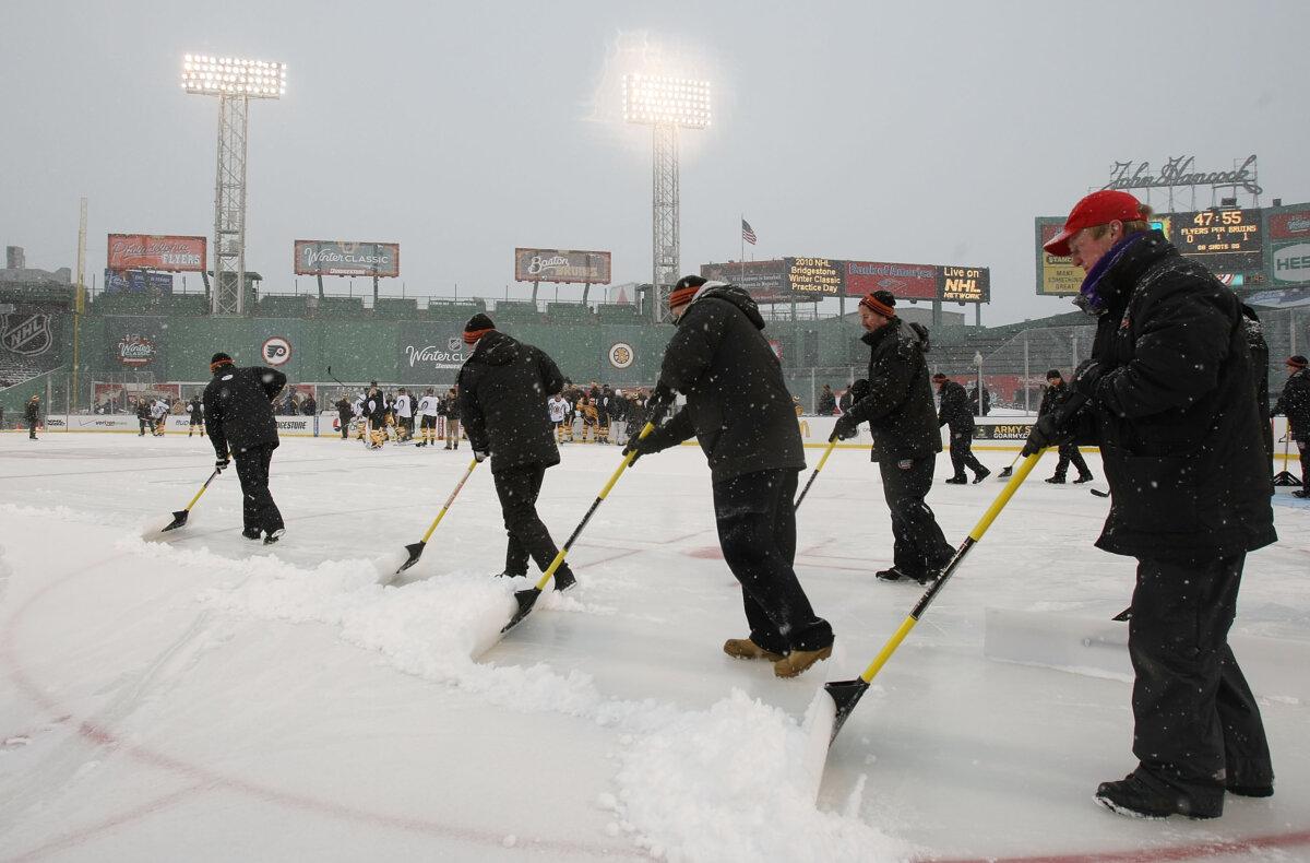 The grounds crew removes snow before the Boston Bruins practice for the Bridgestone NHL Winter Classic at Fenway Park in Boston, Mass., on Dec. 31, 2009. (Elsa/Getty Images)