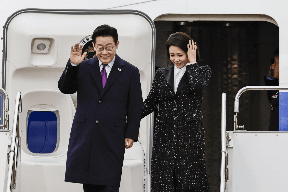South Korean President Lee Jae Myung (L) and his wife, Kim Hea Kyung, arrive at Kansai International Airport in Izumisano city, Osaka, Japan, on Jan. 13, 2026. (Kyodo News via AP)