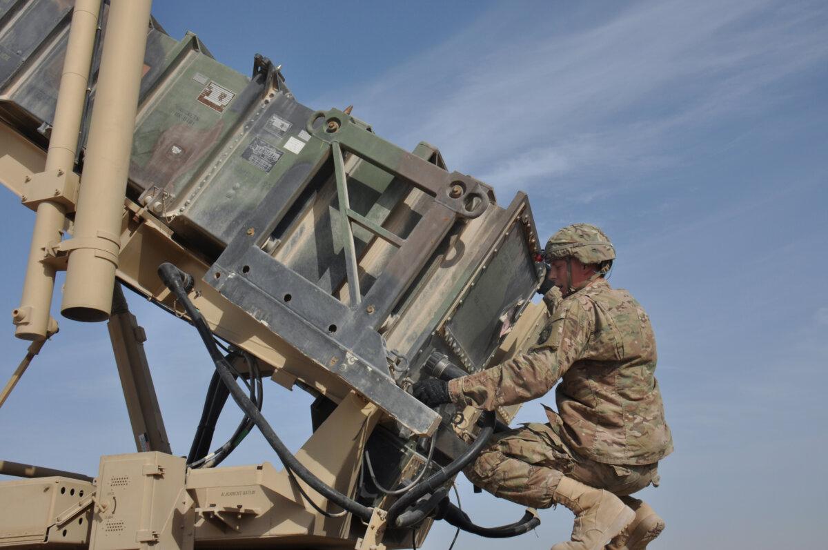 A U.S. soldier assigned to the 1-62 Delta Battery Air Defense Artillery Regiment Patriot provides maintenance on a Patriot launcher at Al Udeid Air Base, Qatar, on March 4, 2015. (Tech. Sgt. James Hodgman/U.S. Air Force via DVIDS)