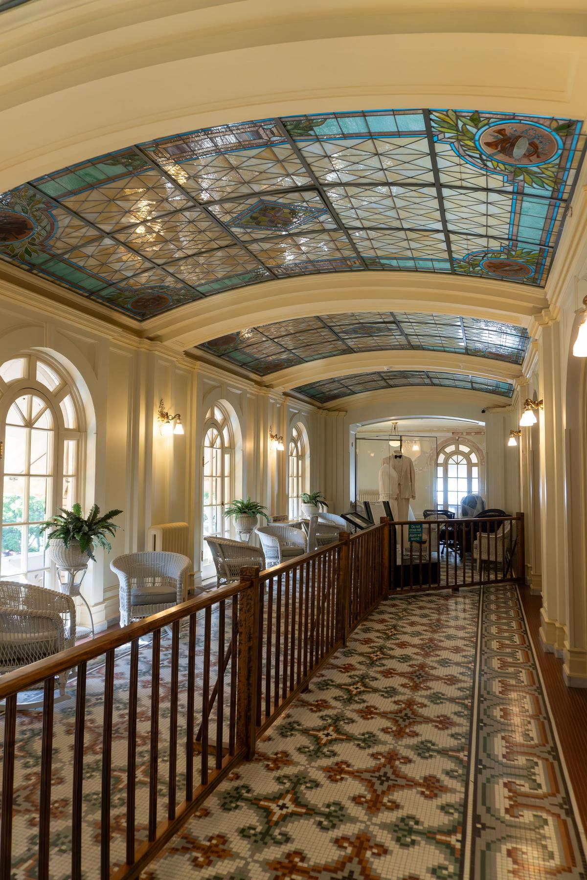 The 100-by-20-foot gathering room on the third floor has been referred to as the assembly room and music room throughout its centuries-plus history. An intricate, patterned-tile floor in varying hues is illuminated by natural light streaming through large, arched windows. The room is made more opulent by its five-panel, arched-vault, stained-glass ceiling. (EWY Media/Shutterstock)
