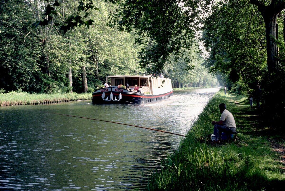A French Waterways barge encounters a fisherman along a canal in Loire. (Photo courtesy of Victor Block)