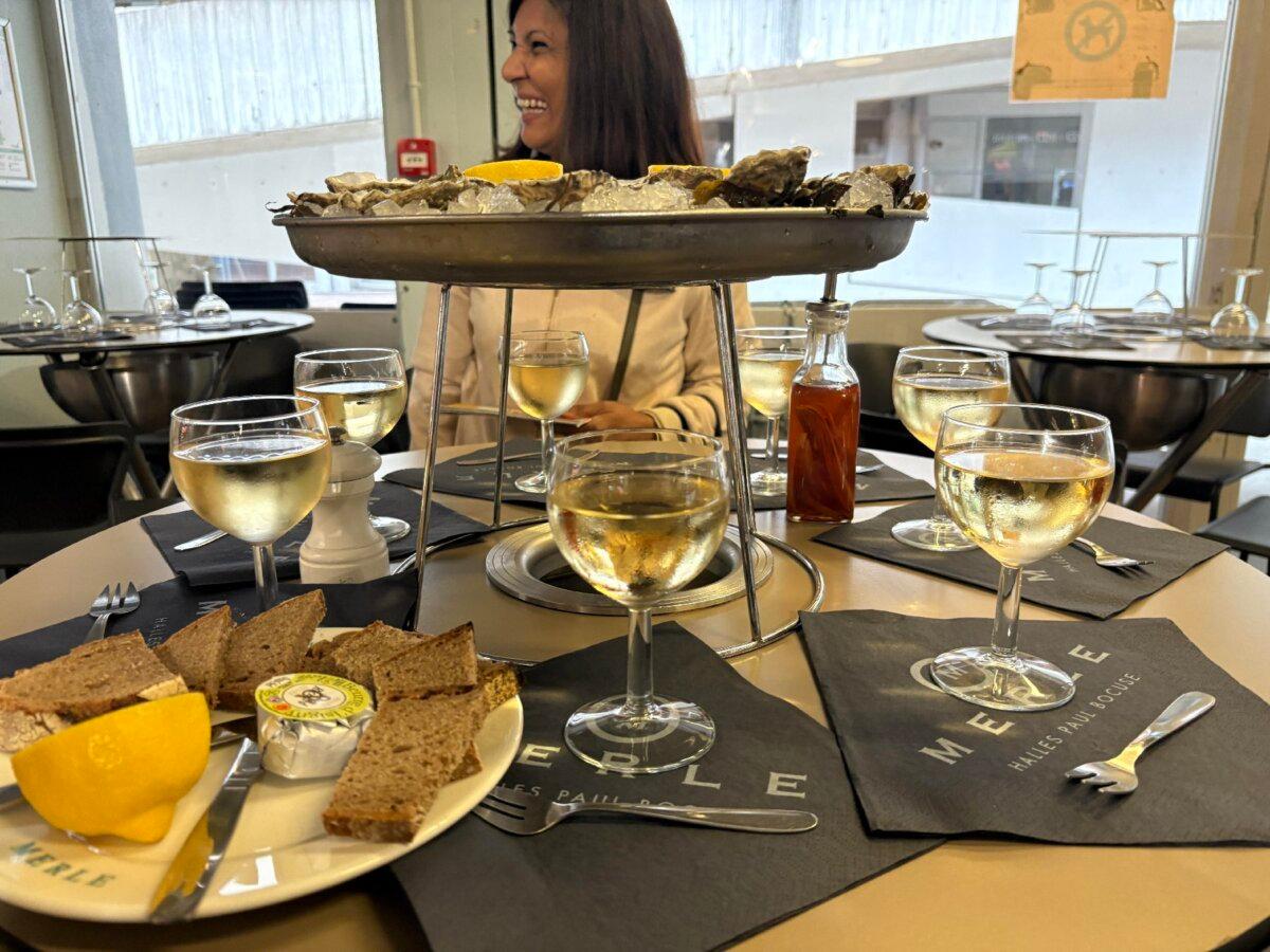 A lunch of oysters and Beaujolais blanc is served at Les Halles de Lyon Paul Bocuse. (Georgeanne Brennan)