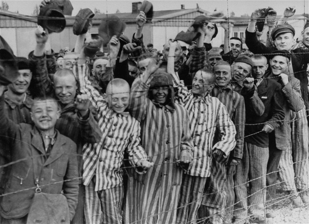 On April 29, 1945, young and old prisoners at the Dachau concentration camp rejoice at the sight of American troops. (Public Domain)
