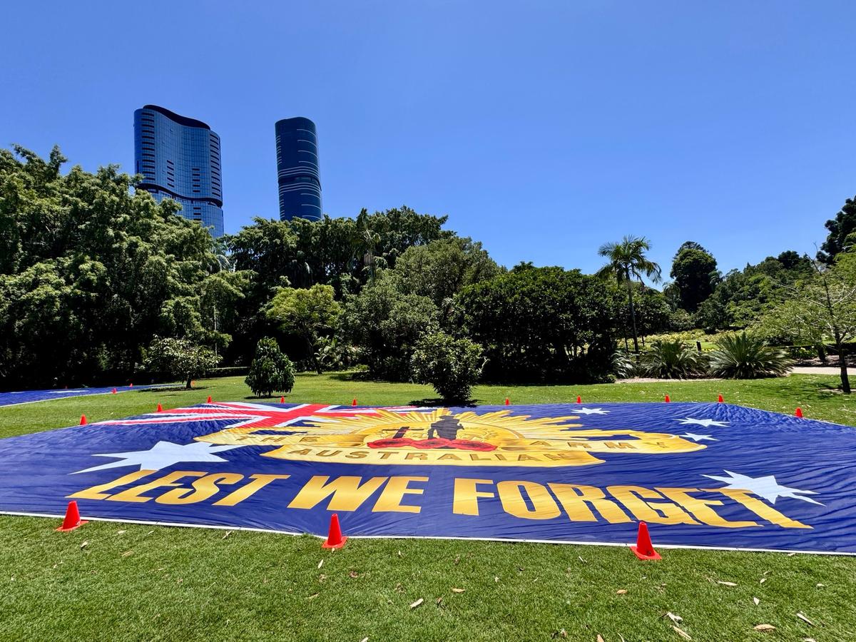 A giant banner commemorating the ANZACs during an Australia Marches event on Australia Day in Brisbane's Botanic Gardens in Australia on Jan. 26, 2026. (Daniel Y. Teng/The Epoch Times)