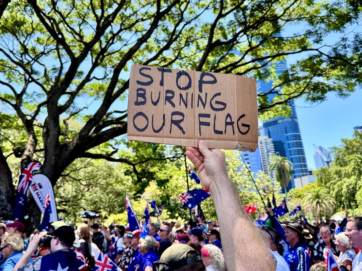 A sign held up during an Australia Marches rally against high immigration on Australia Day in Brisbane, Australia on Jan. 26, 2026. (Daniel Y. Teng/The Epoch Times)