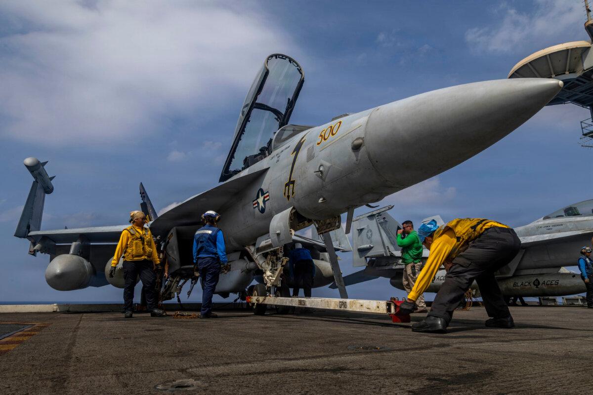 Sailors prepare a Boeing EA-18G Growler on the flight deck of the aircraft carrier USS Abraham Lincoln in the Indian Ocean on Jan. 21, 2026. (Mass Communication Specialist Seaman Daniel Kimmelman/U.S. Navy via AP)