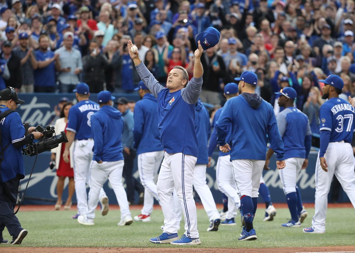 Manager John Gibbons (C) of the Toronto Blue Jays salutes the fans after their victory and his final home game as manager after their MLB game against the Houston Astros at Rogers Centre in Toronto, Canada, on Sept. 26, 2018. (Tom Szczerbowski/Getty Images)