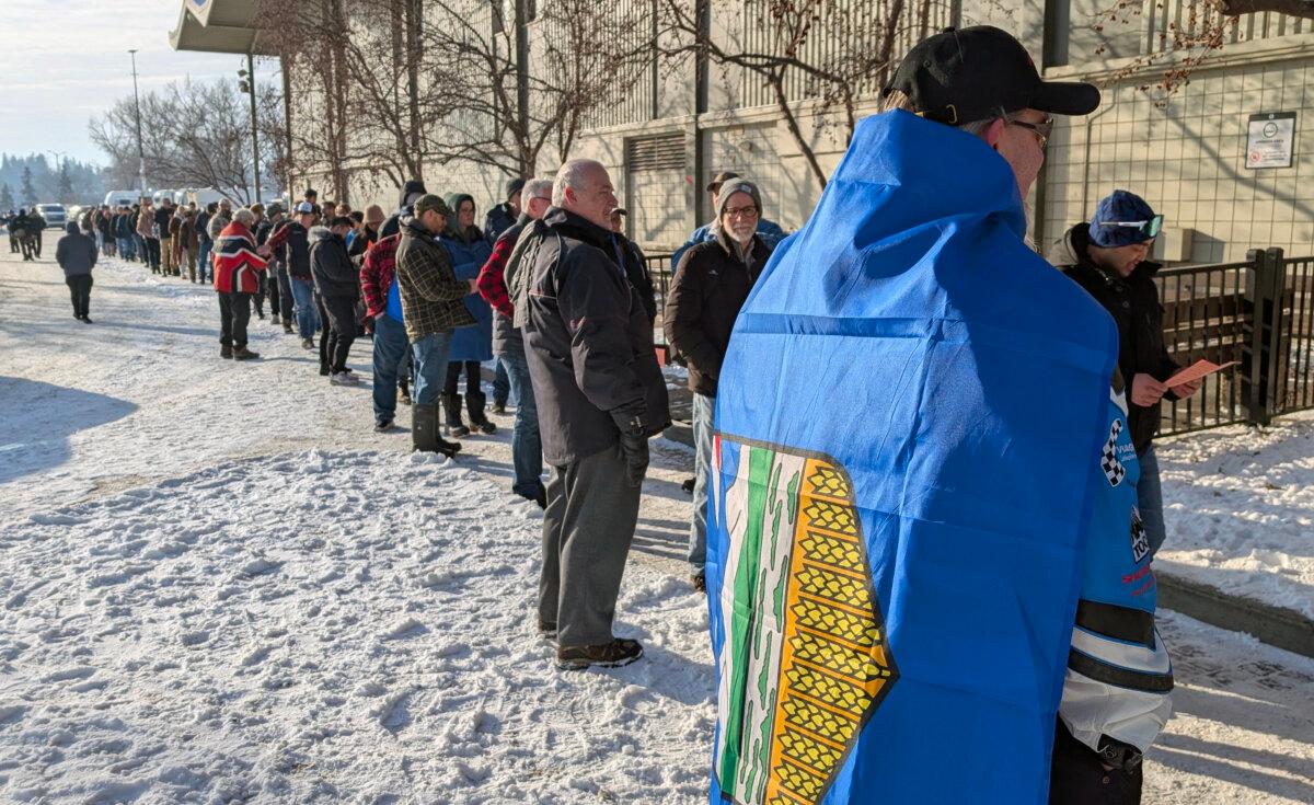 People line up at the Big Four Building to sign a petition triggering a referendum asking if Alberta should secede from Canada, in Calgary on Jan. 26, 2026. (The Canadian Press/Dayne Patterson)