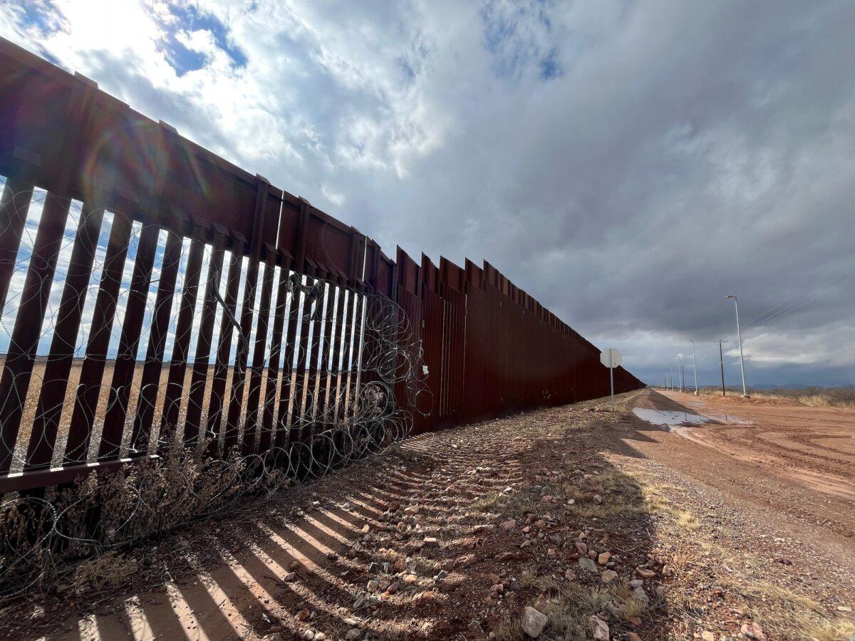 Security fencing measuring 18 feet in height merges with 30-foot steel fencing built during President Donald Trump's first term in Douglas, Ariz., on Jan. 22, 2026. (Allan Stein/The Epoch Times)