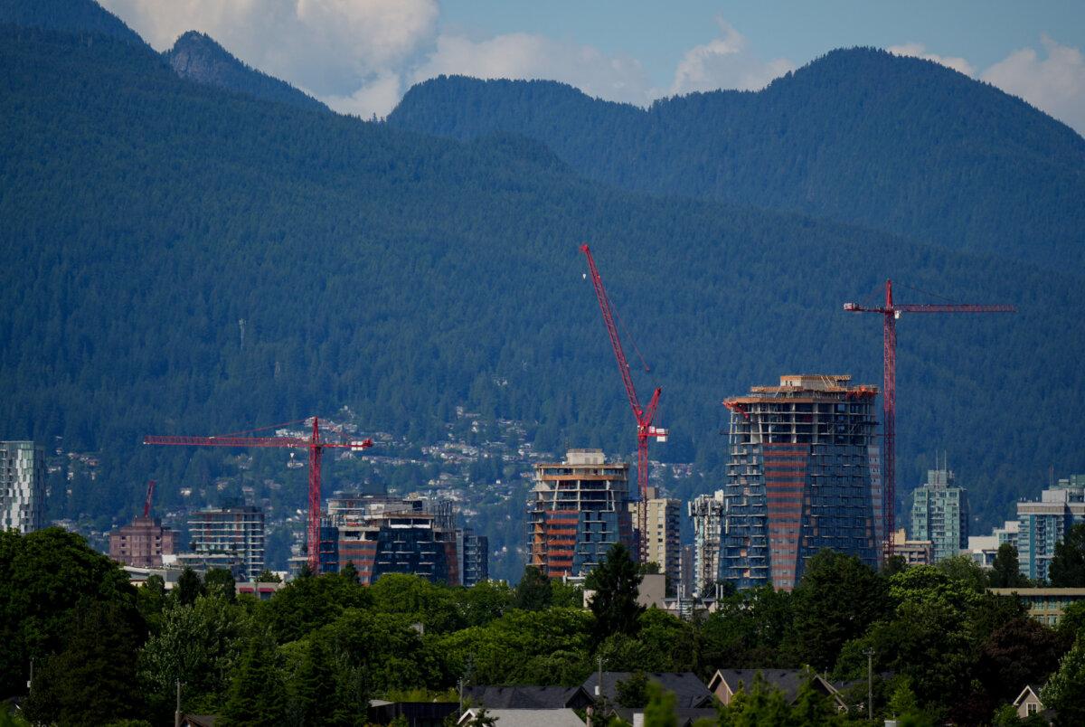 Construction cranes tower above buildings under construction in Vancouver on July 4, 2025. (The Canadian Press/Darryl Dyck)