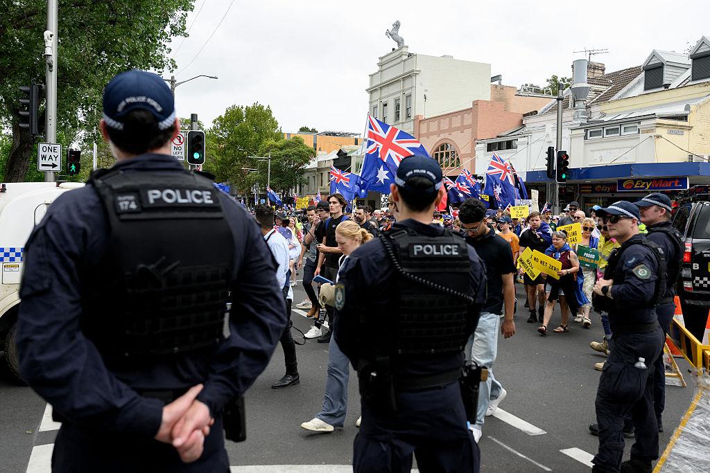 Police keep watch as people take part in a anti-immigration 'March for Australia' rally in Sydney, Australia, on Jan. 26, 2026. (Steven Markham/AFP via Getty Images)