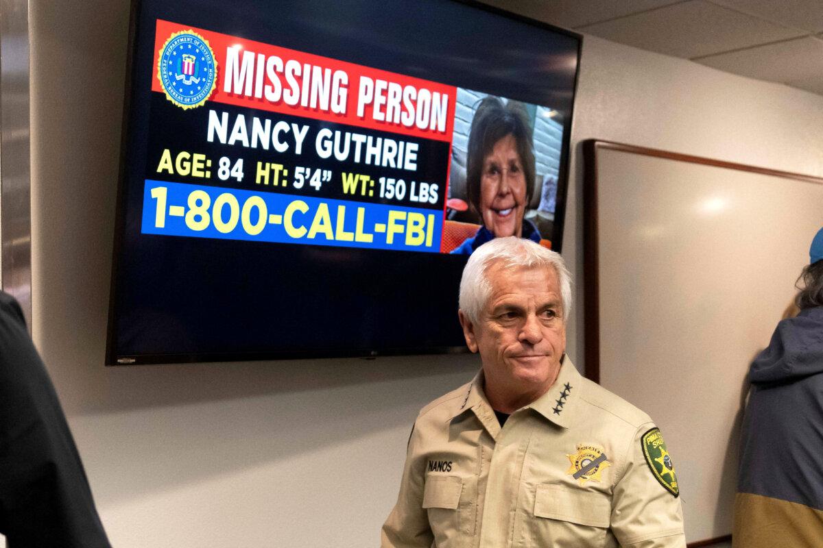 Pima County Sheriff Chris Nanos exits the press room past a missing persons poster after giving an update on the investigation after the disappearance of Nancy Guthrie, the 84-year-old mother of TV host Savannah Guthrie, in Tucson, Ariz., on Feb. 5, 2026. (Rebecca Noble/Reuters)