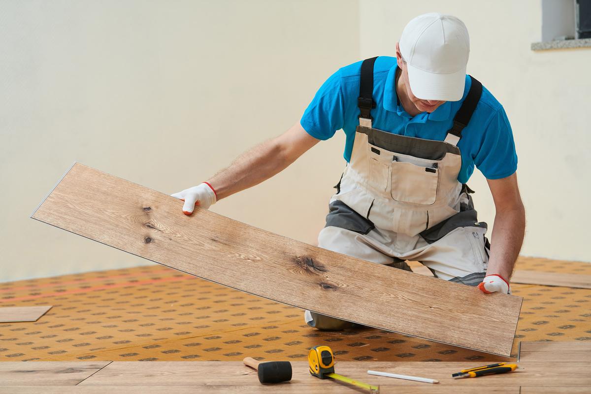 Vinyl planks can be cut cleanly with a utility knife, making installation accessible for many DIY homeowners. (Dmitry Kalinovsky/Shutterstock)