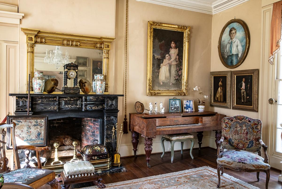 The Sherwood Forest home is filled with several generations of Tyler descendants’ and their spouses’ furnishings, heirlooms, artifacts, and paintings. The drawing room features a treasure trove of historical pieces such as the tapestry-covered chair with cabriole legs, tasseled stool with claw feet, the mahogany piano on turned Ionic capital-adorned legs, and the tapestry-covered fireplace screen. Over the Egyptian black marble fireplace mantel is an American classical gilt-wood mirror with a fluted column design. (Sherwood Forest Plantation Foundation)
