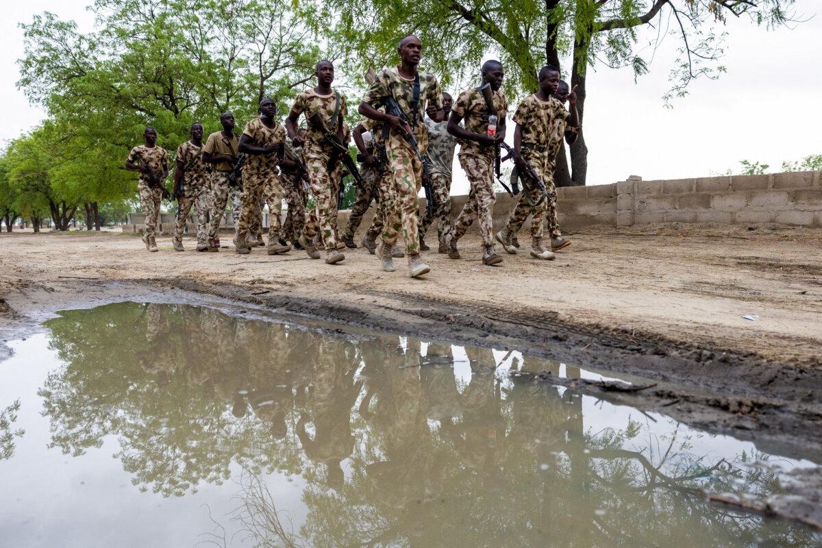 Nigerian soldiers from the Multinational Joint Task Force run at the MNJTF military base in Monguno, Nigeria, on July 5, 2025. (Joris Bolomey/AFP via Getty Images)