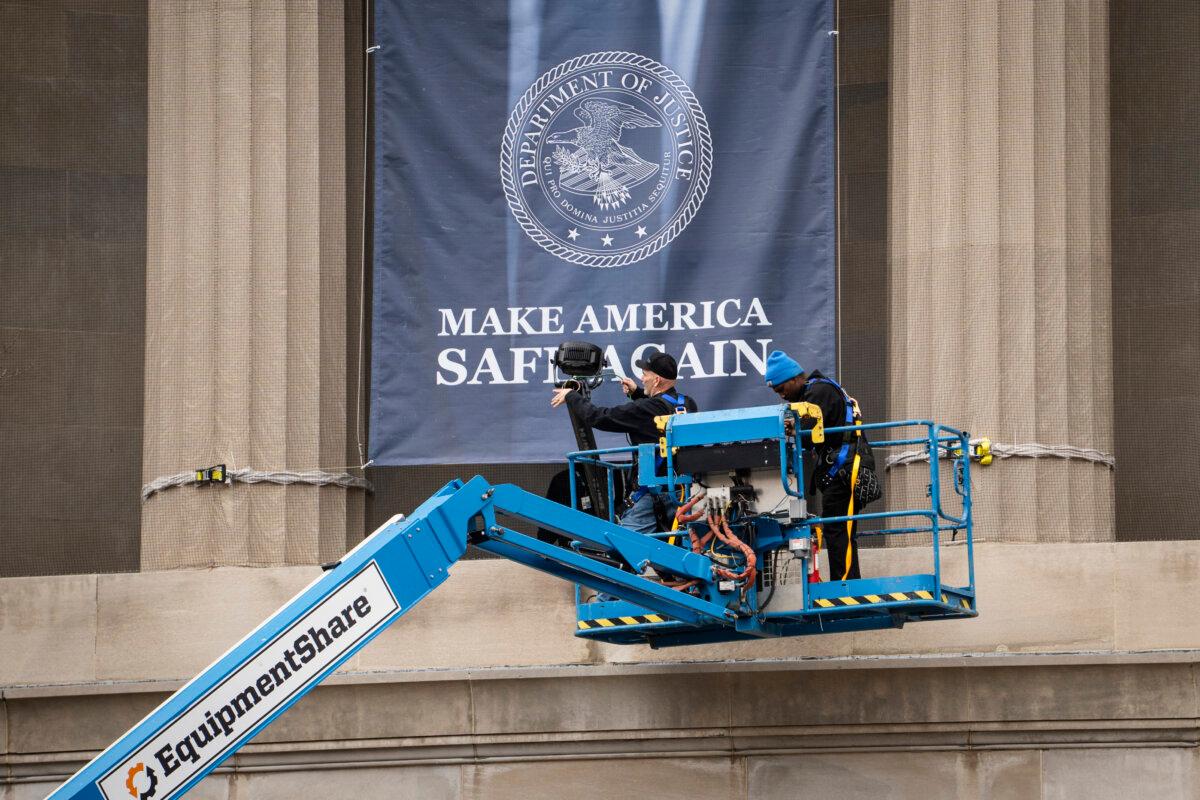 A banner showing President Donald Trump at the Department of Justice in Washington on Feb. 21, 2026. (Madalina Kilroy/The Epoch Times)