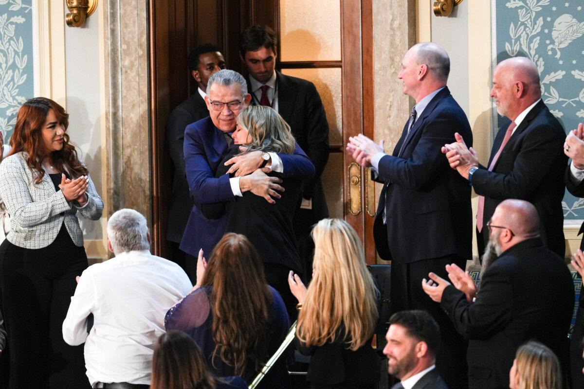 Former Venezuelan presidential candidate and recently released political prisoner Enrique Marquez hugs his niece at President Donald Trump's first State of the Union address during his second presidential term, in the House Chamber on Capitol Hill in Washington on Feb. 24, 2026. (Madalina Kilroy/The Epoch Times)