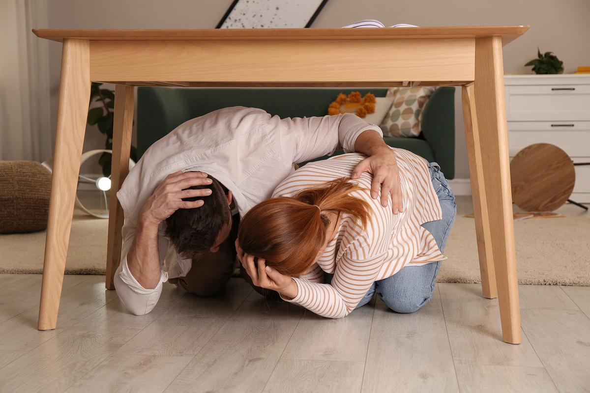 Tables and desks provide protection from falling objects and debris during earthquakes. (New Africa/Shutterstock)