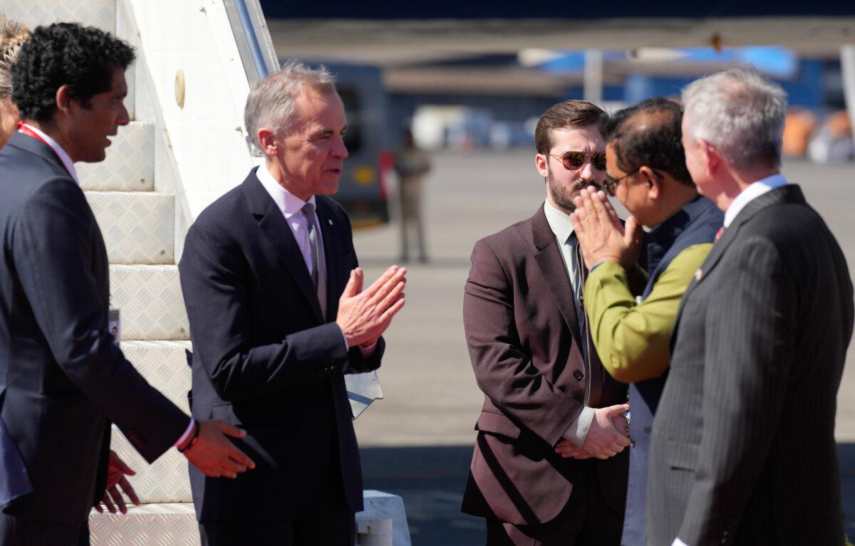 Prime Minister Mark Carney is greeted by Jaykumar Rawal, minister of protocol, government of Maharashtra as he arrives in Mumbai, India, Feb. 27, 2026. (Adrian Wyld/The Canadian Press)