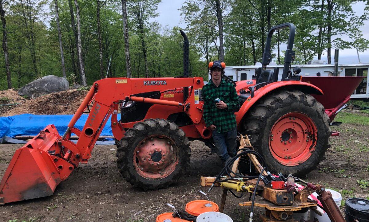 Cattle farmer Neil Ryan stands with his tractor at MacIsaac Highland Cattle farm in Corinth, Vt. (Courtesy of Neil Ryan)