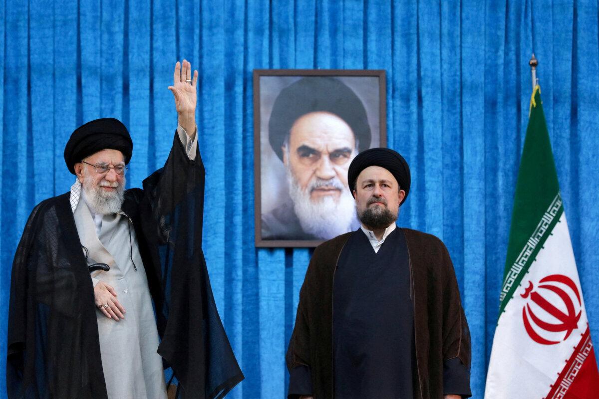 Former Iranian regime leader Ruhollah Khomeini's grandson Hassan Khomeini stands next to Iranian leader Ayatollah Ali Khamenei during the 36th anniversary of the death of Khomeini, the founding leader of the Islamic Republic of Iran, at Khomeini's shrine in southern Tehran, Iran, on June 4, 2025. (Office of the Iranian Supreme Leader/WANA/Handout via Reuters)