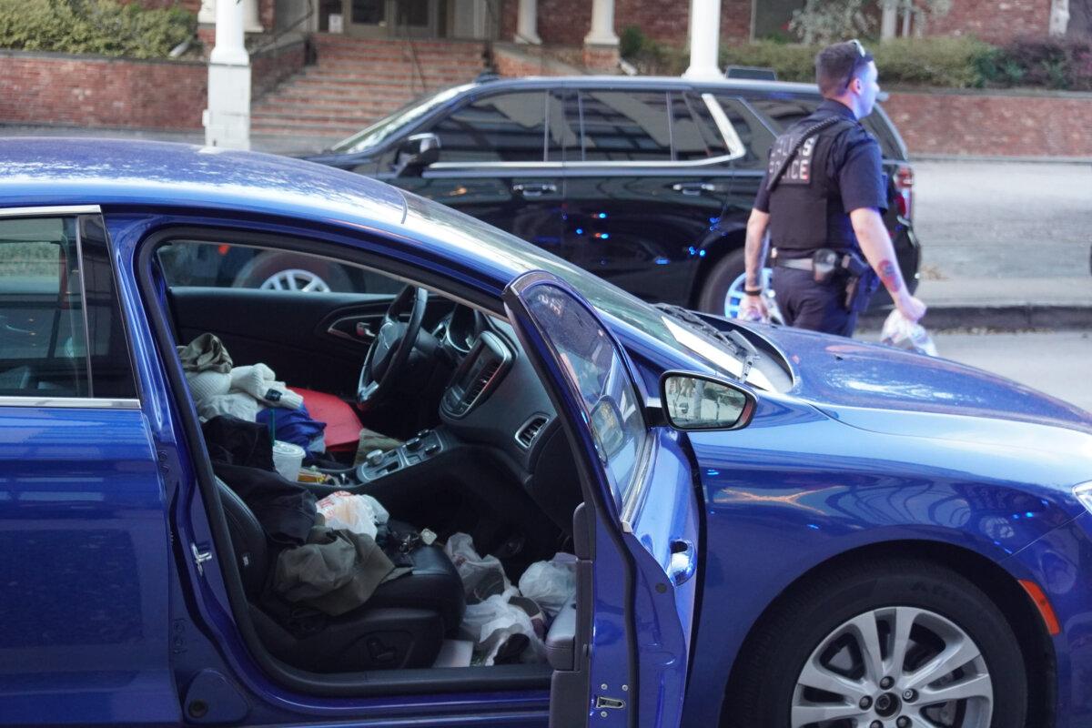 Law enforcement removes bags filled with ammunition from a vehicle outside of Texas Attorney General Ken Paxton's election night party in Dallas, Texas, on March 3. An occupant of the vehicle was apprehended at the scene. (Nathan Worcester/The Epoch Times)