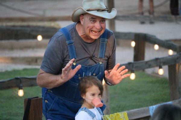 A young girl enjoys meeting friendly farm animals at the petting zoo at Schnepf Farms in Queen Creek, Ariz. (Courtesy of Schnepf Farms)