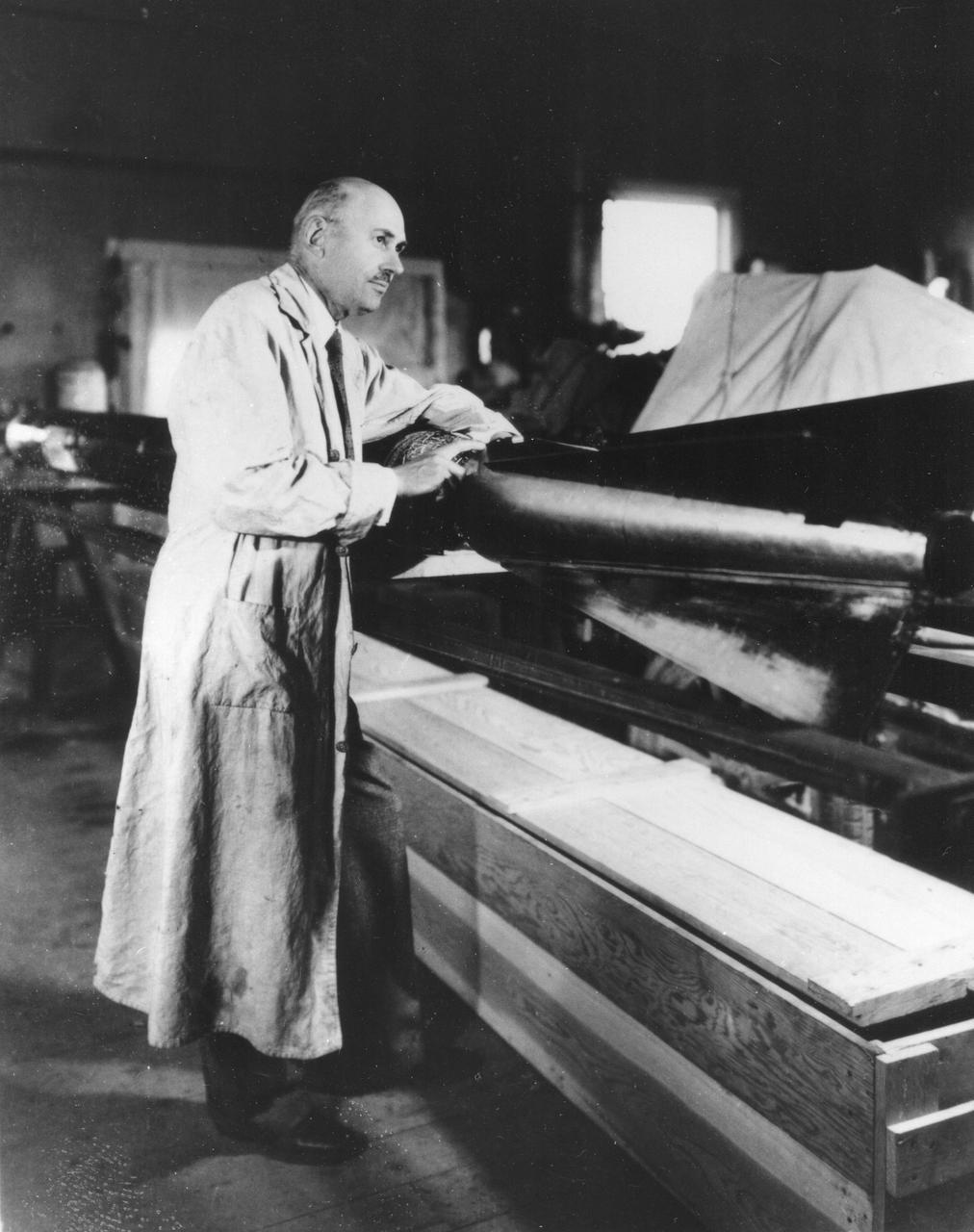 Robert Goddard with a rocket in his workshop at Roswell, N.M. in October 1935. (NASA)