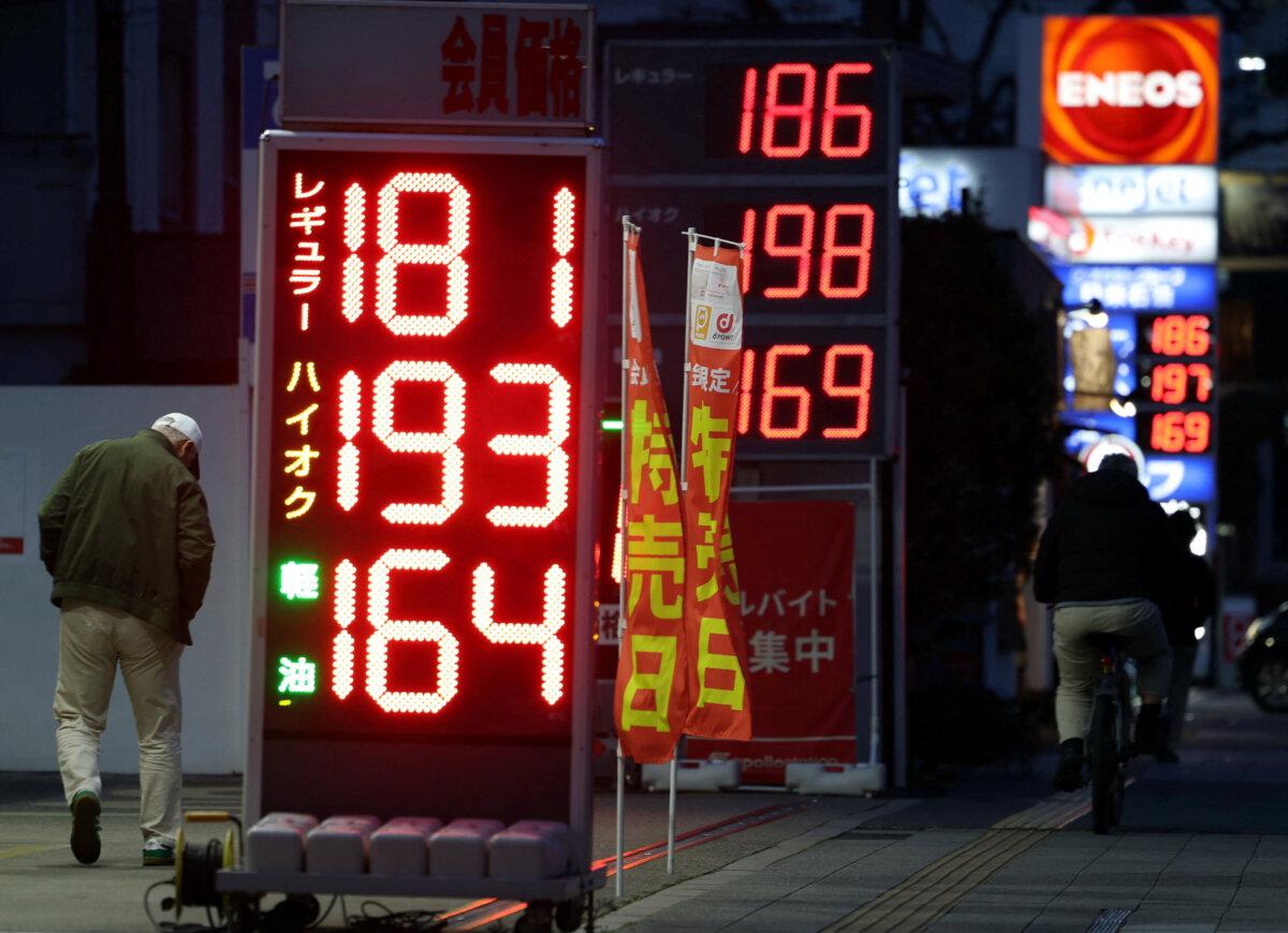 Fuel prices displayed outside gas stations in Tokyo on March 13, 2026. (Issei Kato/Reuters)