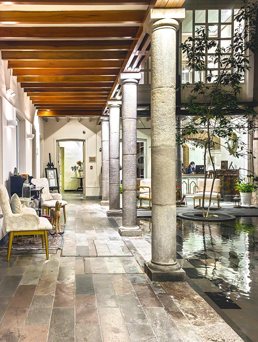The colonnade reflecting pool graces the entry courtyard of Illa Experience Hotel. (Maria Coulson)