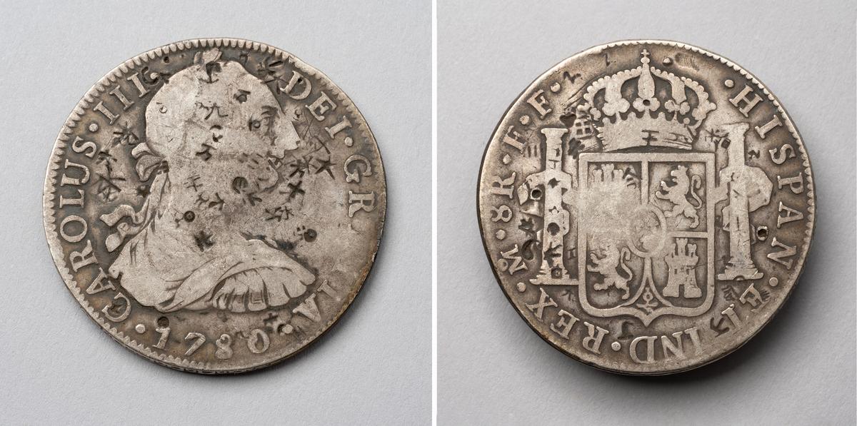Front and back views of Eight Reales (“Pieces of Eight”) with Chinese “Chops,” 1780, marked by Assayer “F.F.” Chops. Silver. Imperial Mint, Mexico City. (Courtesy of Independence Seaport Museum)
