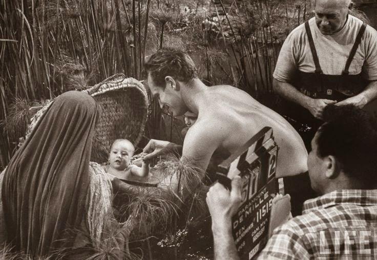 Charlton Heston tends to his son, Fraser, as baby Moses on the set of "The Ten Commandments." (Paramount)
