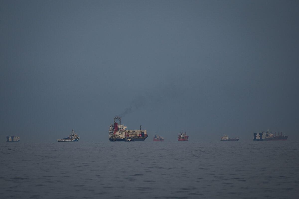 Oil tankers and cargo ships line up in the Strait of Hormuz as seen from Khor Fakkan, United Arab Emirates, on March 11, 2026. (Altaf Qadri/AP)
