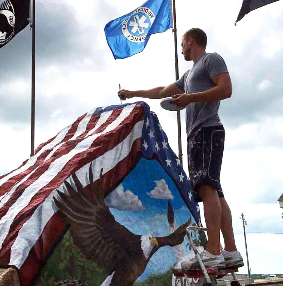 Sorensen makes final touches on a boulder depicting an eagle and an American flag. (Sorensen Studios)