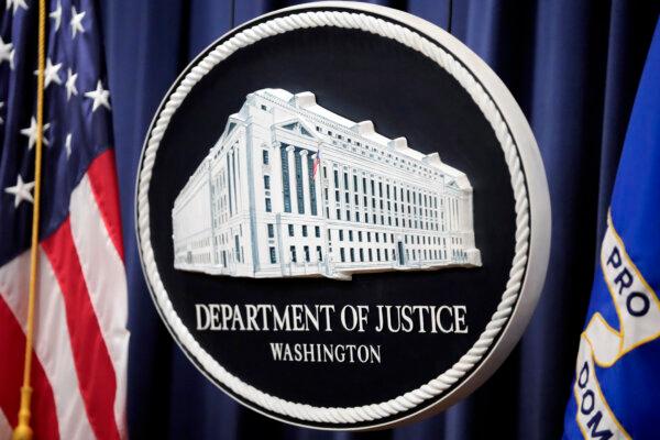 The logo for the U.S. Department of Justice is seen prior to a news conference at the department in Washington, D.C., on Aug. 23, 2024. (Mark Schiefelbein/AP Photo)