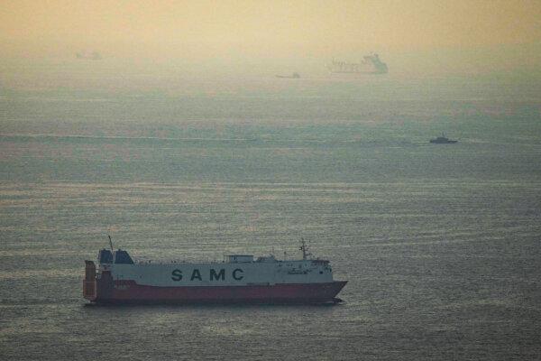 Cargo ships sail in the Arabian Gulf off the United Arab Emirates toward the Strait of Hormuz on March 19, 2026. (AP Photo)