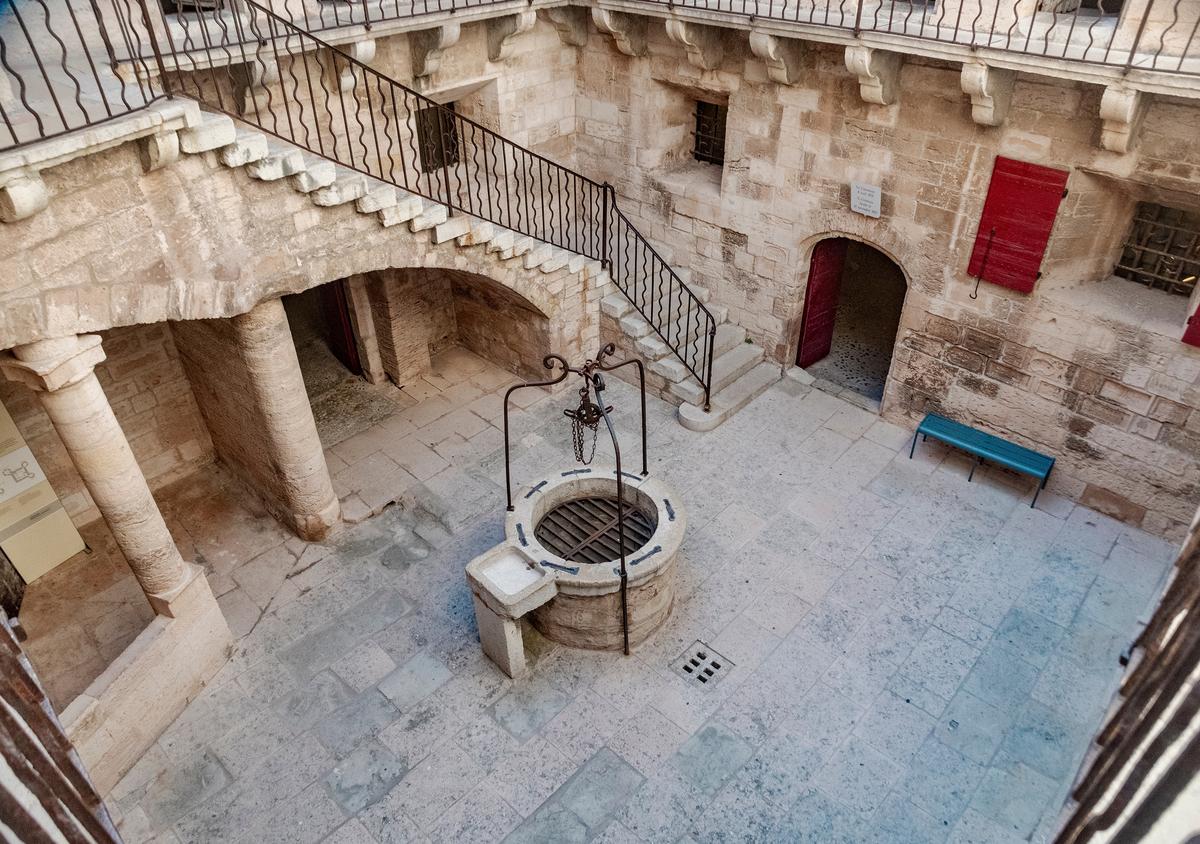 The inner courtyard once held the kitchens, a grain storage, and a rainwater well while also serving as the gateway to the lower dungeons. Its walls are etched with 96 inscriptions left by revolutionaries imprisoned between 1848 and 1849. (Lisa Liidemann/Shutterstock)
