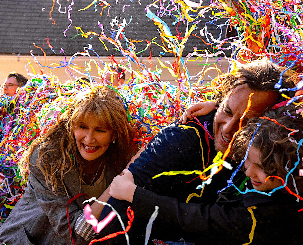 (L–R) Tess (Laura Dern), Alex (Will Arnett), and Jude (Calvin Knegton) having birthday party fun, in "Is This Thing On?" (Jason McDonald/Searchlight Pictures)