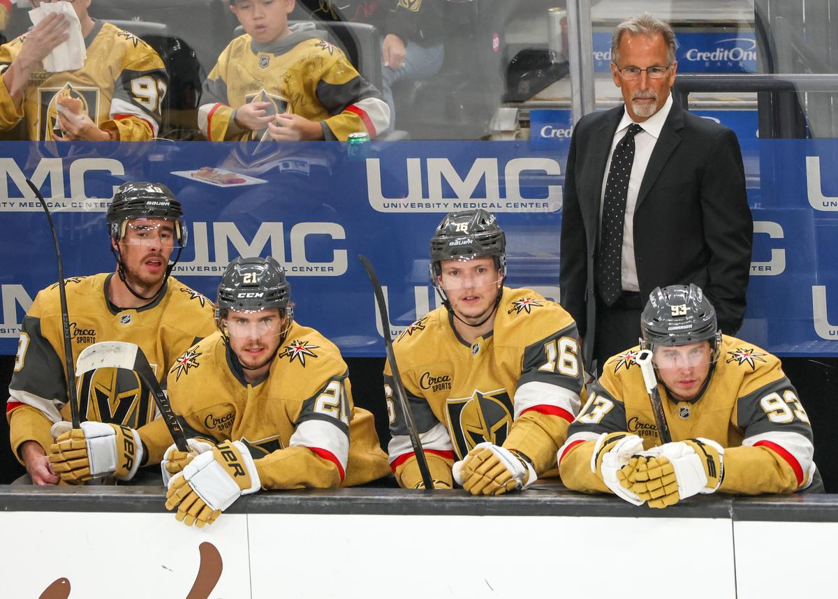 Head coach John Tortorella handles bench duties during his first game with the Vegas Golden Knights, behind Reilly Smith #19, Brett Howden #21, Pavel Dorofeyev #16, and Mitch Marner #93 in the first period of the team's game against the Vancouver Canucks at T-Mobile Arena in Las Vegas on March 30, 2026. (Ethan Miller/Getty Images)
