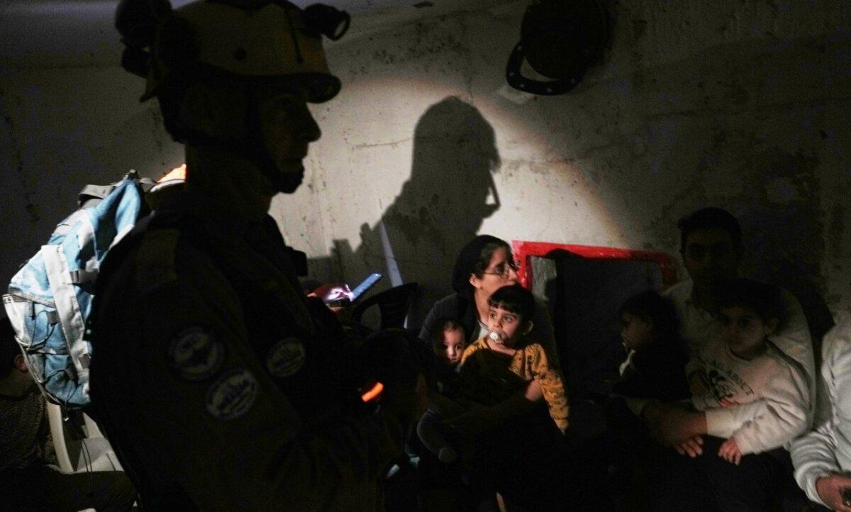 Rescue teams and residents take shelter as sirens sound next to a site struck by an Iranian missile in Bnei Brak, Israel, on April 1, 2026. (Oded Balilty/AP)