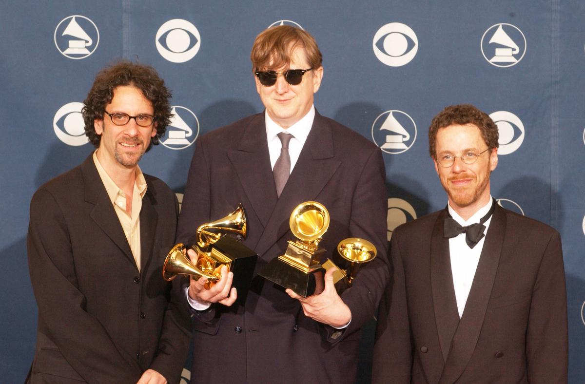(L–R) Director Joel Coen, producer T Bone Burnett, and director Ethan Coen pose with their awards for Album of the Year during the 44th Annual Grammy Awards, 2002, in Los Angeles. (Vince Bucci/Getty Images)