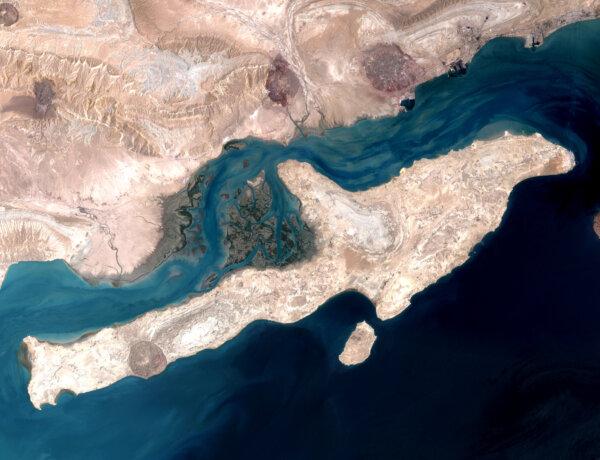 Analysts say that seizing Qeshm Island at the mouth of the Strait of Hormuz could weaken Iran's ability to disrupt maritime traffic. The island is seen here in a satellite image on Aug. 23, 2000. (NASA)