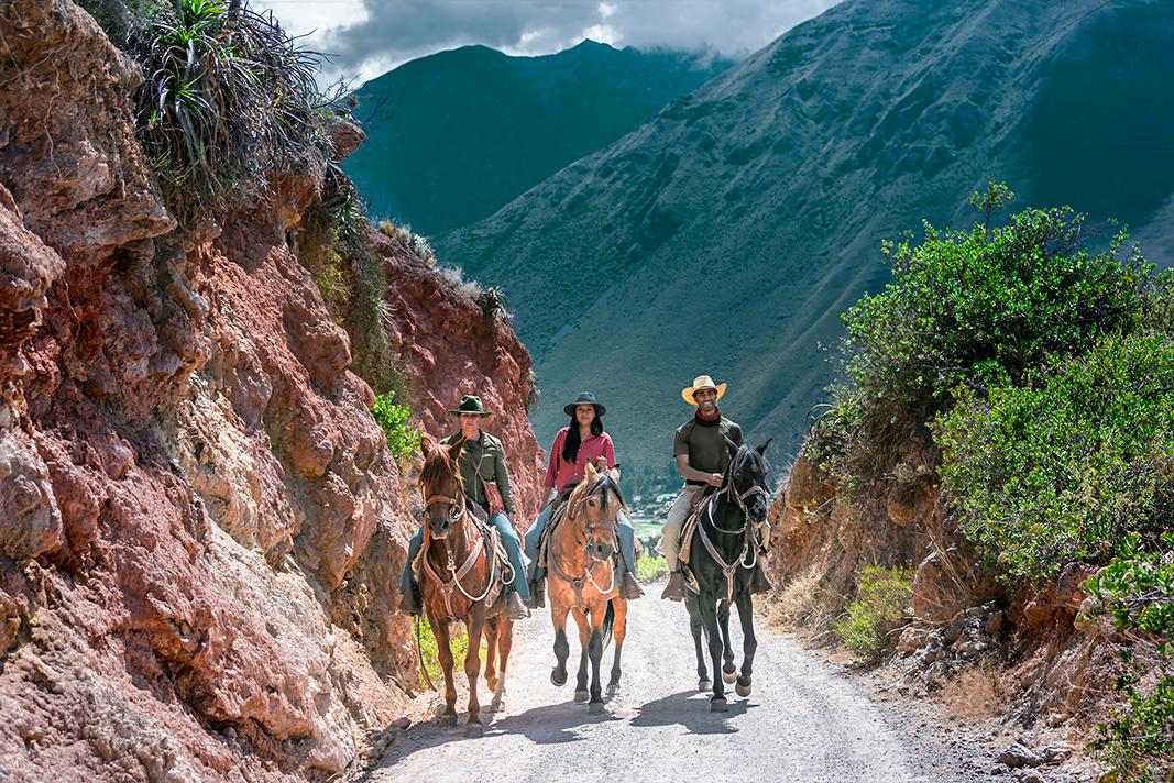Salineras Ranch wranglers (L–R) Adriana Abril, Paula Abril, and Yunus Sheikh riding prized Peruvian Paso horses in the Sacred Valley. (Maria Coulson)