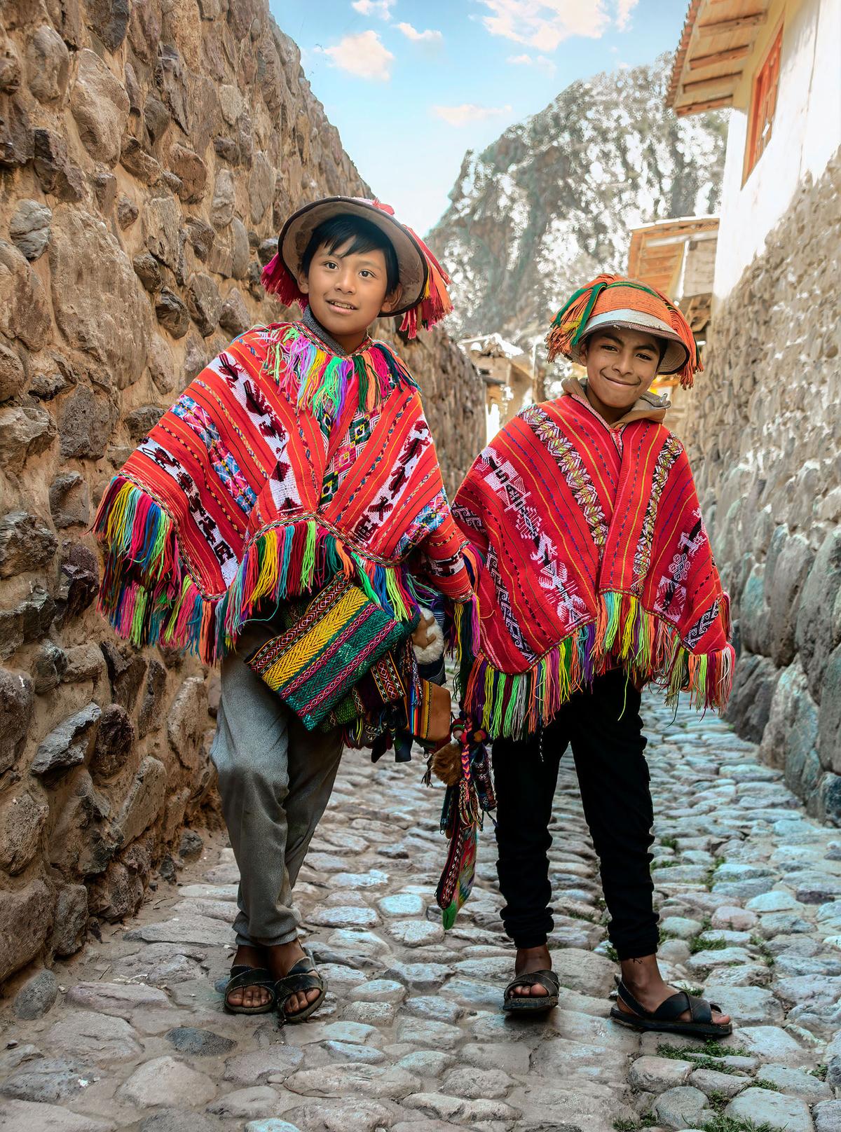 Dayron Monarga, 11, and Rony Hancco, 12, stand together on a narrow, cobblestone street in the Incan town of Ollantaytambo. (Maria Coulson)