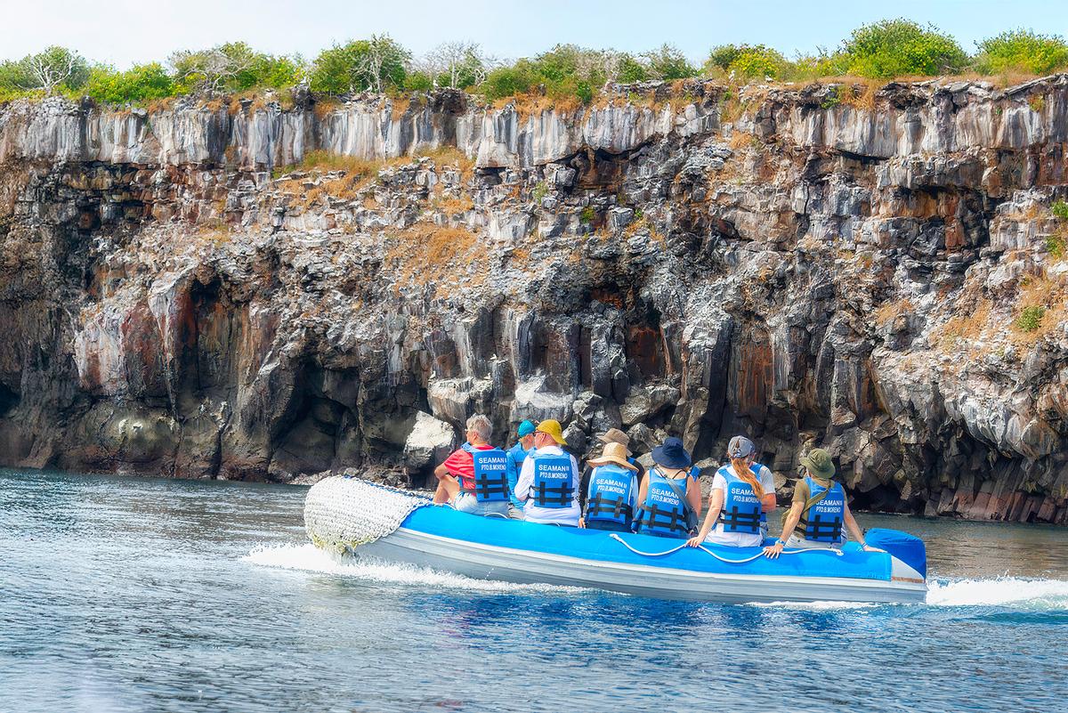 <span style="font-weight: 400;">Zodiac passengers cruising by the igneous cliffs of Genovesa Island. </span> (Maria Coulson)