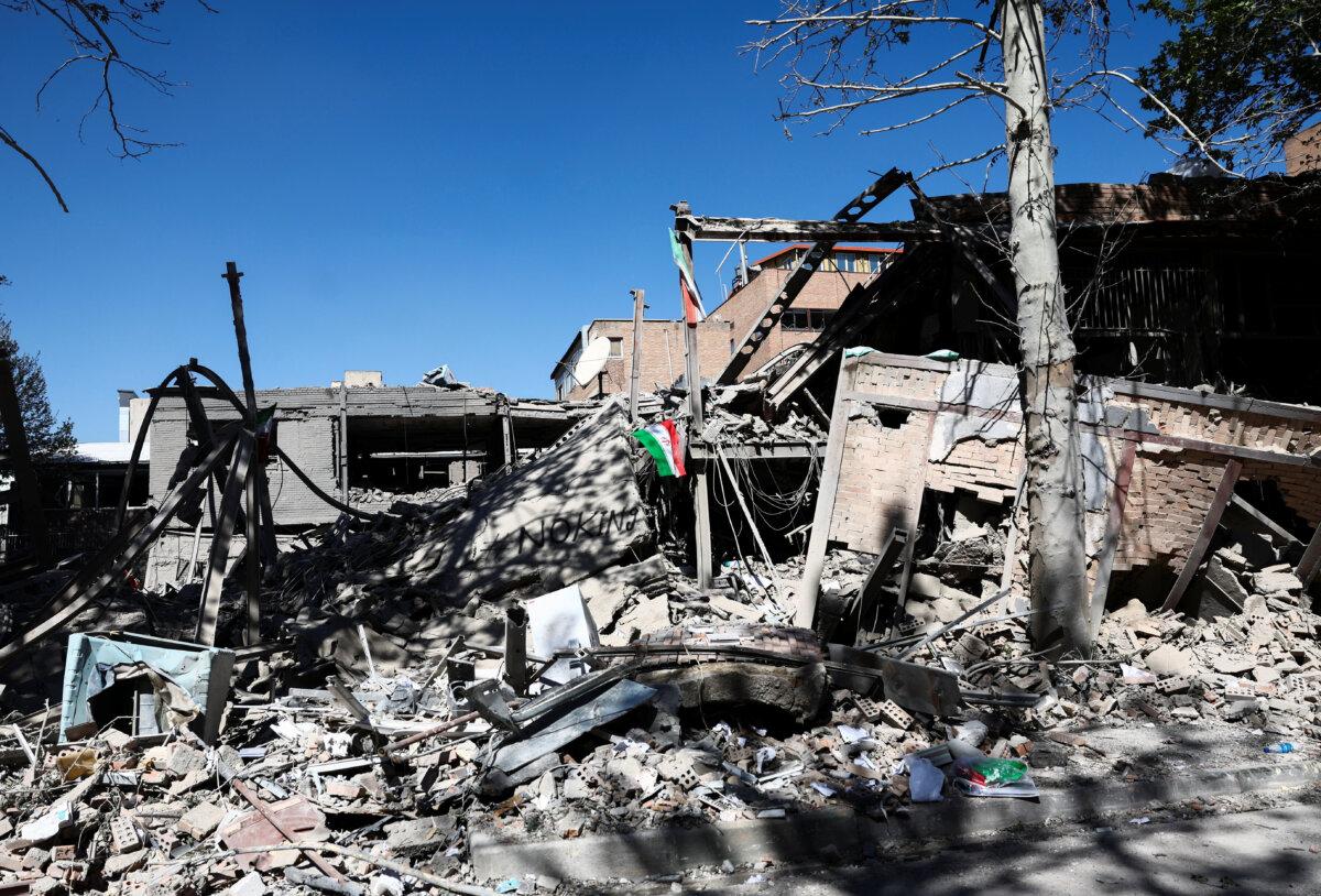 An Iranian flag lies amidst the rubble of a building of the Sharif University of Technology, which was damaged in a strike, amid the U.S.-Israeli conflict with Iran, in Tehran, Iran, April 7, 2026. (Majid Asgaripour/WANA (West Asia News Agency) via Reuters)