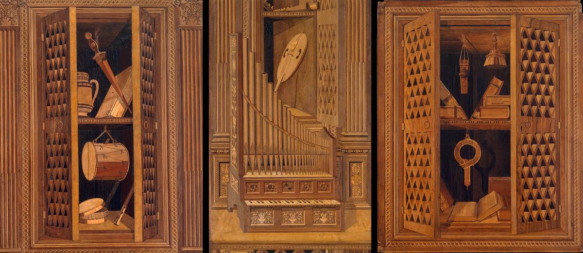 <span style="color: #0000ff;">A compilation of three panel details from "Studiolo" from the Ducal Palace in Gubbio. (Left to Right) </span> The upper section of panel detail of cupboard with tabor, pipe, box filled with candied fruits, dagger and book; a detail of an organ and fiddle from panel 5; and the upper section of panel 7 featuring cupboard with Order of the Garter, books, quill case with lead inkwell, and jeweled whisk broom. Metropolitan Museum of Art, New York City. (Public Domain)