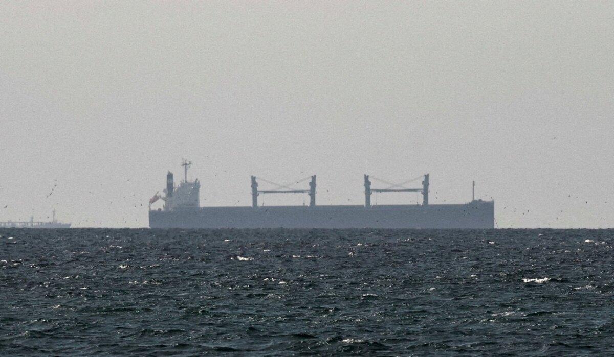A cargo ship sits at anchor in the Gulf of Oman, near the Strait of Hormuz, as seen from northern Ras al-Khaimah, near the border with Oman’s Musandam governorate, in United Arab Emirates, March 11, 2026. (Stringer/Reuters)