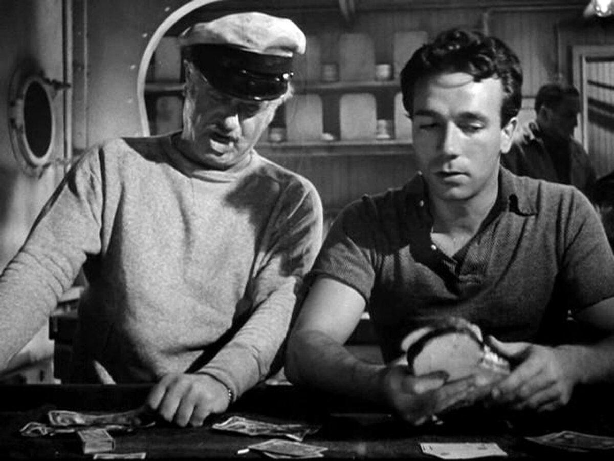 Boats O’Hara (Alan Hale, L) breaks out in song next to Johnnie Pulaski (Dane Clark), in “Action in the North Atlantic.” (Warner Bros. Pictures)